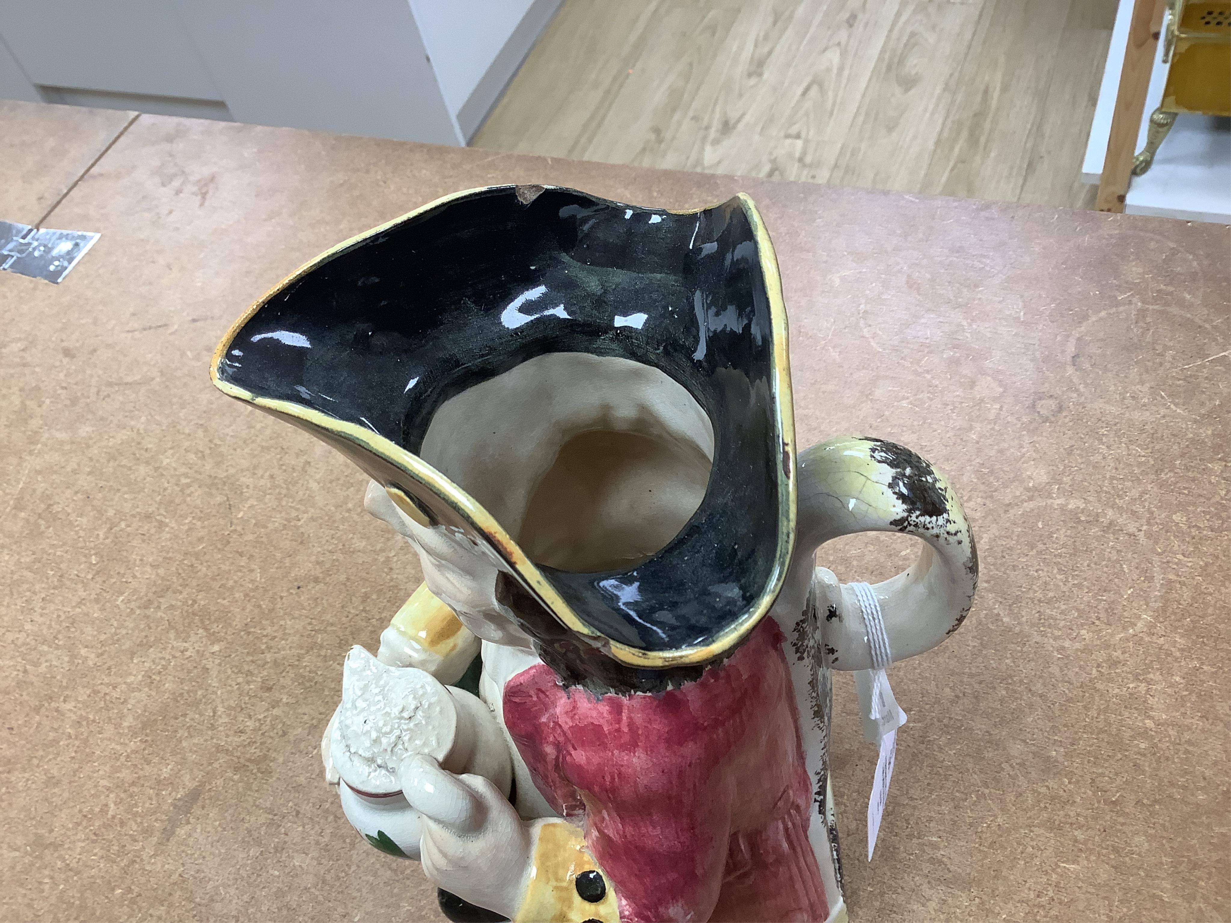 A Yorkshire Toby jug, c.1800, modelled holding a frothing jug, pink coat and green breeches, 26.5cm high